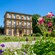 An 18th century multilevel mansion featuring statues at the entrance